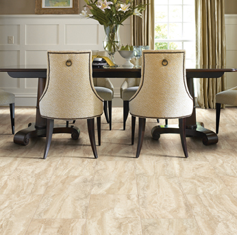 Elegant dining room with a dark table and light marble-look tile flooring.
